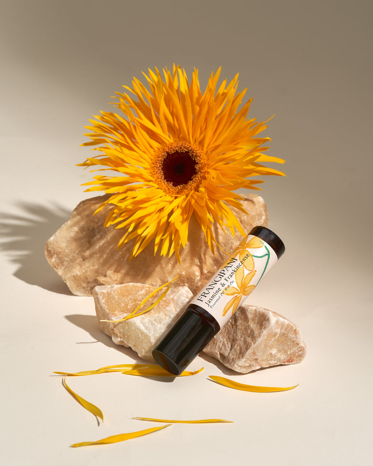 Frangipani Jasmine & Frankincense roll-on with a golden spider dahlia