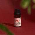 Frangipani Litsea Cubeba essential oil bottle on a deep red background