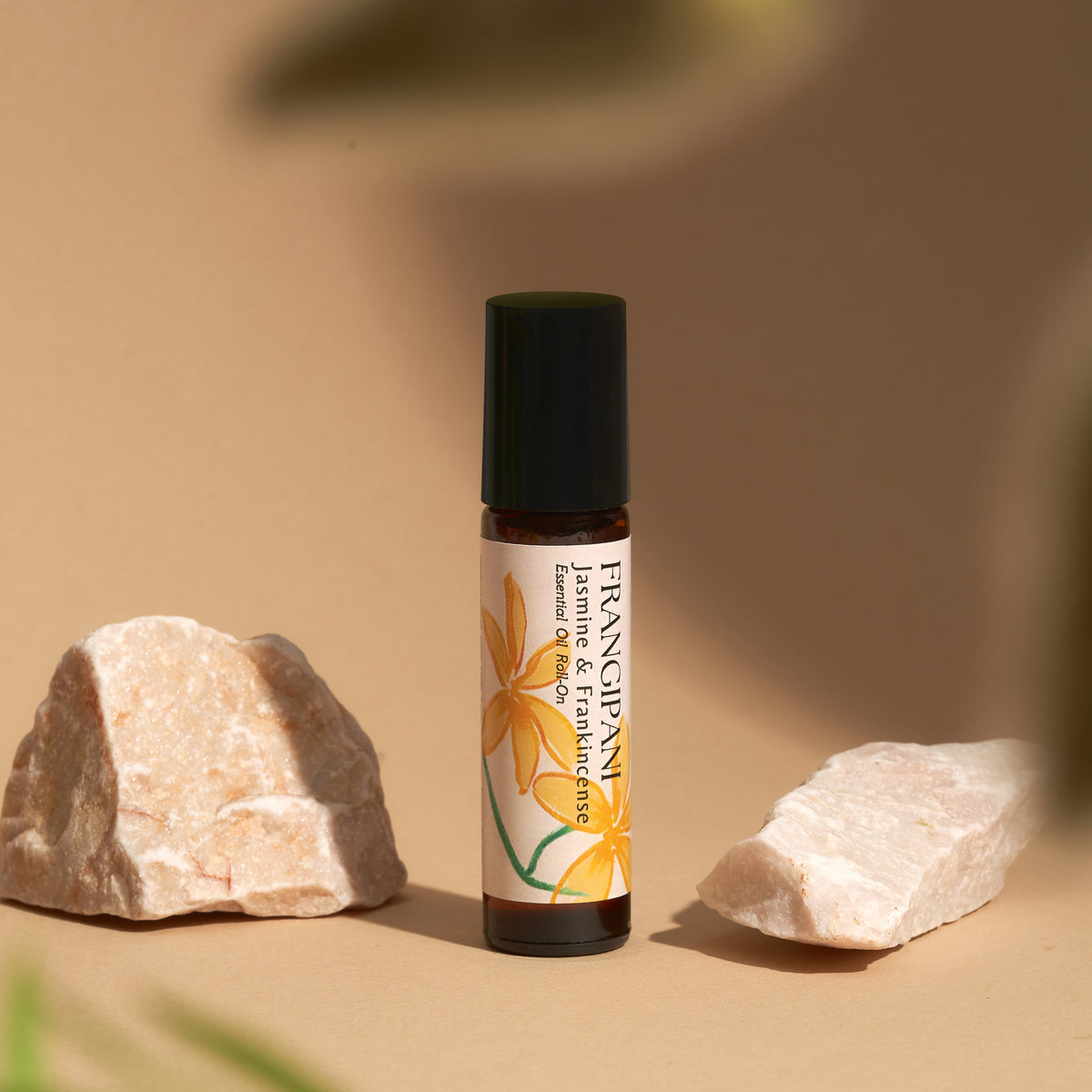 Frangipani Jasmine & Frankincense roll-on between pink stones