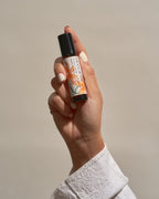 Hand holding the Frangipani Litsea Cubeba & Bergamot roll-on