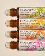 Close-up of four Frangipani roll-on scents with hand-painted floral labels