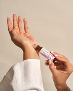 Applying Frangipani Lavender & Hinoki roll-on to the inner wrist