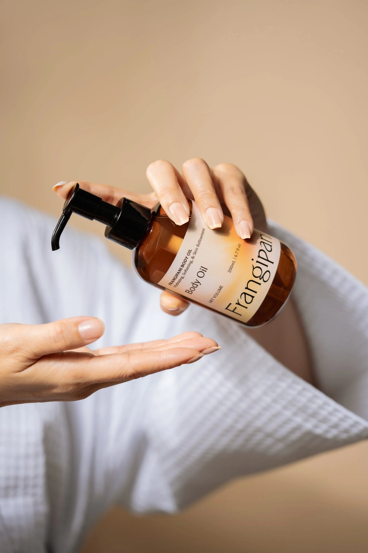 Massaging Frangipani Body Oil into the skin