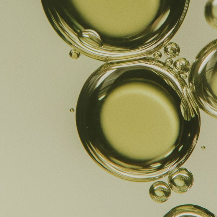 Close-up of oil droplets on a light background